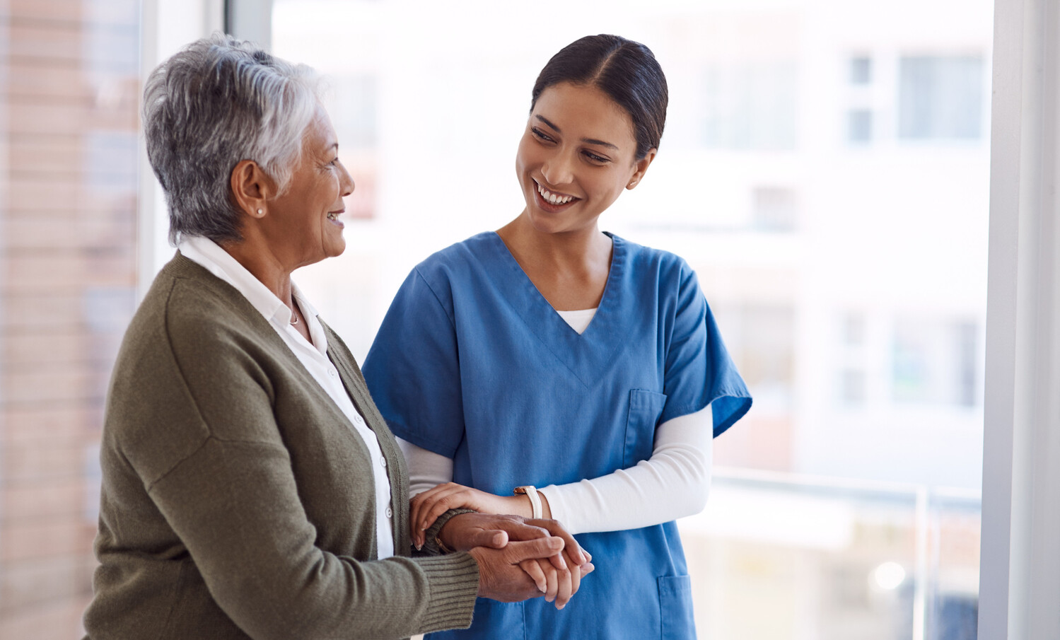 Ill always be here by your side. a young nurse caring for a senior woman. Physiotherapy, holding hands and help with walking stick for support, recovery and guide at home.